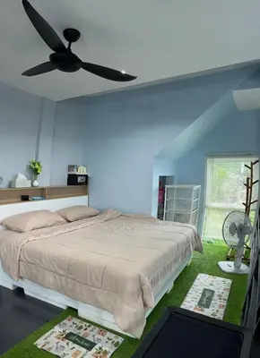 a bedroom with a bed and a ceiling fan at Spacious Garden Loft Home Studio Workation & Fit in Ban Na Nai