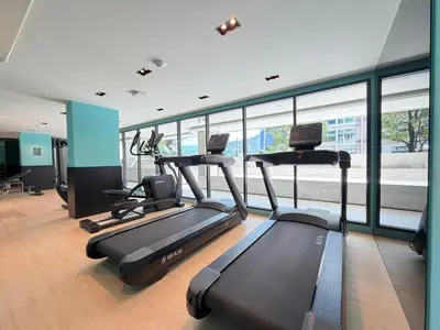 a gym with two treadmills and two exercise bikes at Gloria's Laguna Nest in Ban Thalat Choeng Thale