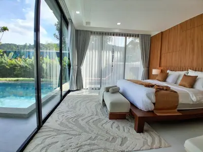 a bedroom with a large bed and a pool at Andara Ao Nang Pool Villa in Ao Nang Beach