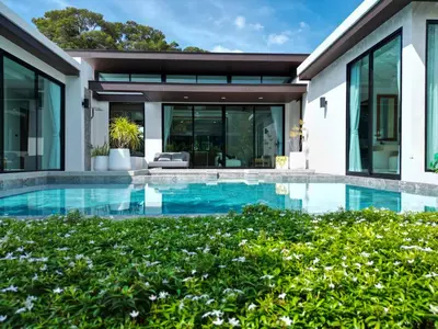 an exterior view of a house with a swimming pool at Andara Ao Nang Pool Villa in Ao Nang Beach