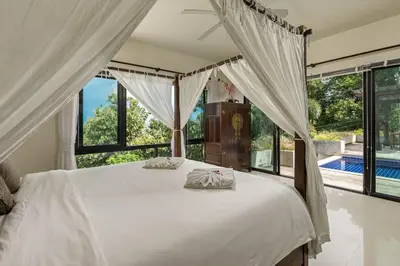 a bedroom with a white bed and a large window at Ao Yon- Contemporary 3-bedroom private pool villa in Ban Ao Makham