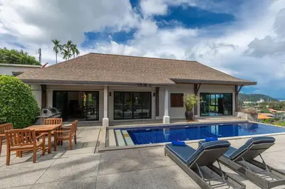a house with a swimming pool and a table and chairs at Ao Yon- Contemporary 3-bedroom private pool villa in Ban Ao Makham