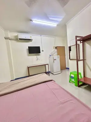 a hospital room with a bed and a refrigerator at Khan House Patong in Patong Beach