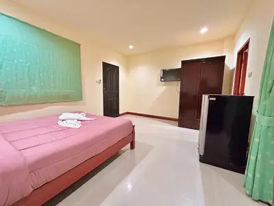 a bedroom with a bed and a chalkboard on the wall at Khan House Patong in Patong Beach