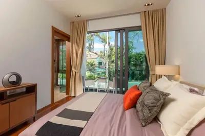 a bedroom with a large bed and a large window at 4-Bed Villa-Sweeping Sunrise View over Chalong Bay in Ban Saiyuan (1)