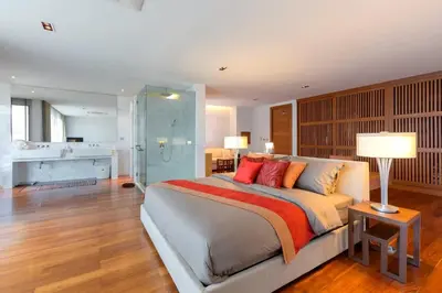 a bedroom with a large bed with red pillows at 4-Bed Villa-Sweeping Sunrise View over Chalong Bay in Ban Saiyuan (1)