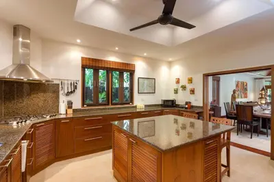 a large kitchen with a ceiling fan and a table at Villa Barron - Spacious Luxury Family Holiday Home in Chalong