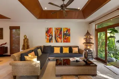 a living room with a couch and a ceiling fan at Villa Barron - Spacious Luxury Family Holiday Home in Chalong