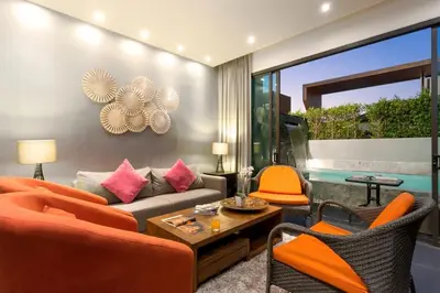 a living room with an orange couch and chairs at 2-Bed Pool Villa Chalong-Bright Modern & Relaxing in Ban Suan