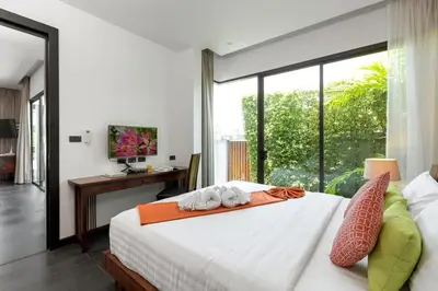 a bedroom with a bed and a large window at 2-Bed Pool Villa Chalong-Bright Modern & Relaxing in Ban Suan