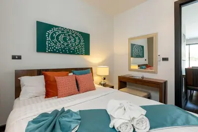 a bedroom with a bed with towels on it at 2-Bed Pool Villa Chalong-Bright Modern & Relaxing in Ban Suan