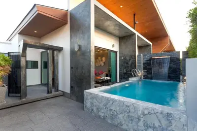 a swimming pool in the backyard of a house at 2-Bed Pool Villa Chalong-Bright Modern & Relaxing in Ban Suan