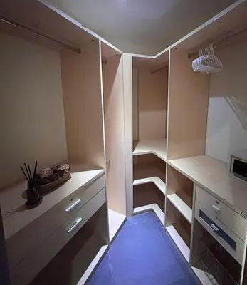 an empty closet with white cabinets and a blue floor at Peaceful 2-Bedroom Villa on Loch Palm Golf Course in Ban Kathu