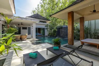a patio with a pool and chairs and a house at Diamond Tree Escape Pool Villa in Bangtao in Ban Pak Lak