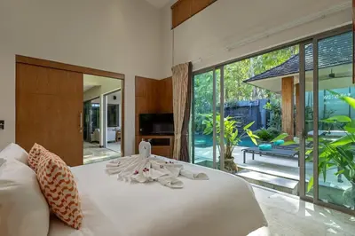 a bedroom with a white bed with towels on it at Diamond Tree Escape Pool Villa in Bangtao in Ban Pak Lak