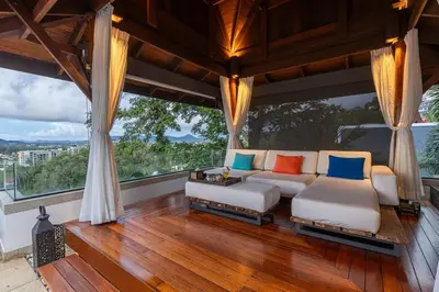 a living room with a couch and large windows at Villa Elan Luxury Surin Villa Panoramic Sea Views in Surin Beach