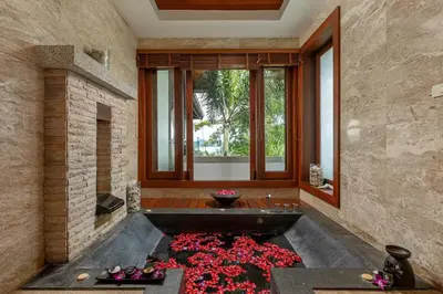 a bathroom with a large tub filled with red flowers at Villa Elan Luxury Surin Villa Panoramic Sea Views in Surin Beach