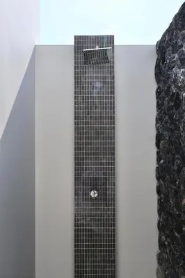 a shower with black tile on the wall at Botanica - Bali Style Luxury 3 BR Private Pool Villa in Ban Pak Lak