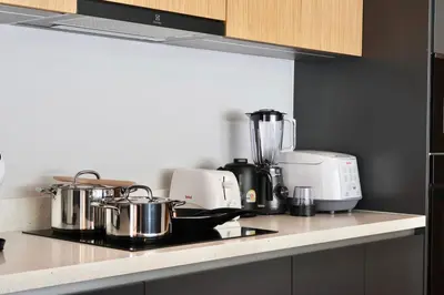 a kitchen counter with pots and pans on a stove at Botanica - Bali Style Luxury 3 BR Private Pool Villa in Ban Pak Lak