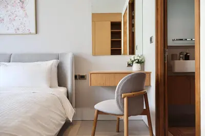 a bedroom with a bed and a chair next to a desk at Botanica - Bali Style Luxury 3 BR Private Pool Villa in Ban Pak Lak