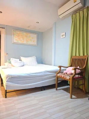 a bedroom with a bed and a chair at Budget Place Homestay-Solo Traveler in Ban Dan