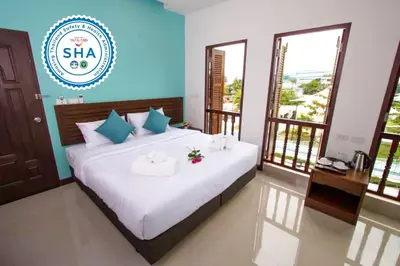 a bedroom with a bed with towels on it at BS Airport at Phuket in Nai Yang Beach