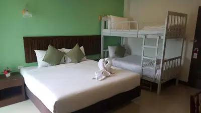 two beds in a room with two bunk beds at BS Airport at Phuket in Nai Yang Beach
