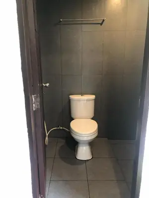 a bathroom with a white toilet in a stall at Phi Phi Green House & Sunsky Hostel in Phi Phi Don