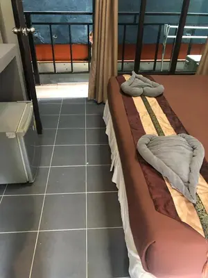 a bedroom with a bed and a tiled floor at Phi Phi Green House & Sunsky Hostel in Phi Phi Don