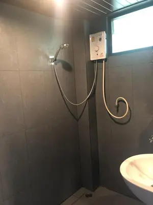 a shower in a bathroom with a sink at Phi Phi Green House & Sunsky Hostel in Phi Phi Don