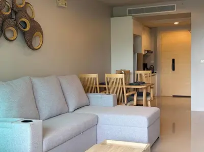 a living room with a couch and a table at Veloche Karon by Investing In Phuket in Ban Karon