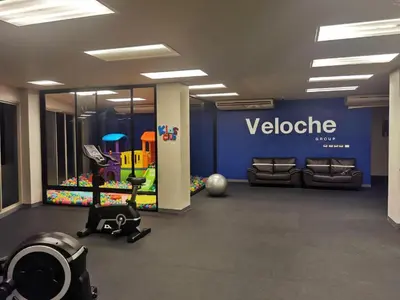 a gym with a welcome sign on the wall at Veloche Karon by Investing In Phuket in Ban Karon