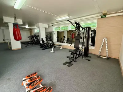 a gym with several tread machines and a punching bag at Comfort SeaView Apartment with Private Plunge Pool in Patong Beach