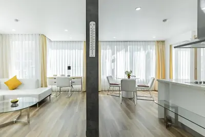 a living room with a white couch and a table at Comfort SeaView Apartment with Private Plunge Pool in Patong Beach