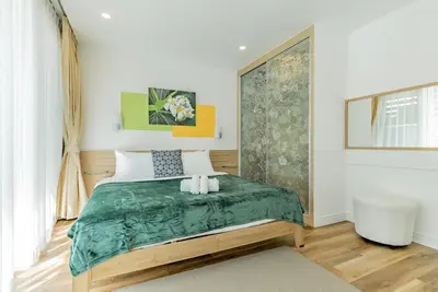 a bedroom with a bed with two candles on it at Comfort SeaView Apartment with Private Plunge Pool in Patong Beach