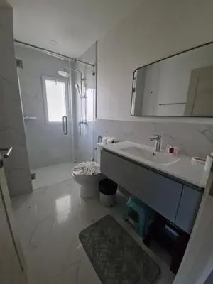 a bathroom with a sink and a shower and a mirror at The nice condo 2 BR at Karon in Karon Beach