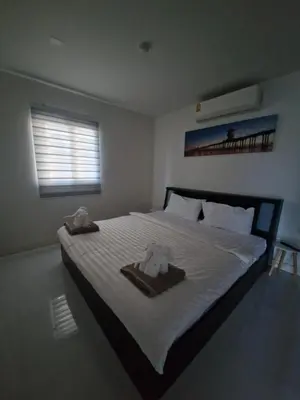 a bedroom with a bed with two towels on it at The nice condo 2 BR at Karon in Karon Beach