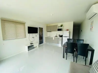 a kitchen and dining room with a table and chairs at The nice condo 2 BR at Karon in Karon Beach