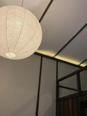 a white light fixture hanging from a ceiling at Kalm Cabin Phuket in Ban Phak Chit