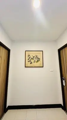 a white wall with a picture on it at Oh'tel Kata in Kata Beach