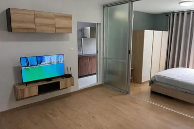 a bedroom with a flat screen tv and a bed at D Condo Kathu Monthly Stay Near Patong 30 Day Minimum in Kathu