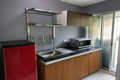 a kitchen with a sink and a microwave at D Condo Kathu Monthly Stay Near Patong 30 Day Minimum in Kathu
