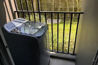 a trash can sitting in front of a fence at D Condo Kathu Monthly Stay Near Patong 30 Day Minimum in Kathu