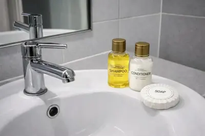 a bathroom sink with two bottles of essential oils on it at D Condo Kathu Monthly Stay Near Patong 30 Day Minimum in Kathu