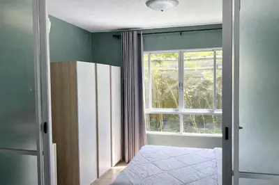 a bedroom with a window and a bed and a door at D Condo Kathu Monthly Stay Near Patong 30 Day Minimum in Kathu
