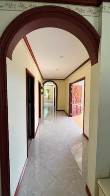 an empty hallway with an archway in a building at Liina House in Ko Yao Noi