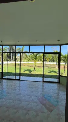 an empty room with glass doors and a view of a park at Liina House in Ko Yao Noi