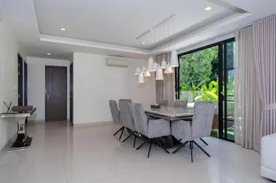 a dining room with a table and chairs at Friendly Lux 5 Bedroom Villa Laguna park in Laguna Phuket