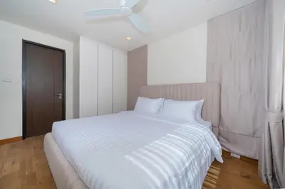 a bedroom with a large white bed with white sheets at Friendly Lux 5 Bedroom Villa Laguna park in Laguna Phuket