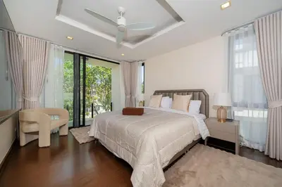 a bedroom with a bed and a ceiling fan at Luxury 5 bed Laguna Park no Pool in Laguna Phuket